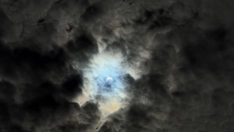 Wide-handheld-shot-of-a-almost-total-solar-eclipse-behind-a-dark-and-overcast-sky-on-a-summer-day-in-Utah-of-2023