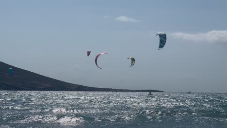 A-large-group-of-kite-surfers-on-the-rough-sea-near-the-coast-of-Paralia-Prasonisiou,-Rhodes