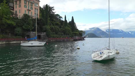 Two-Beautiful-White-Yachts-Floating-near-Varenna-Town-in-Lake-Como