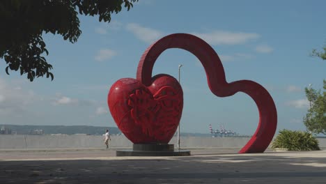 Red-heart-sculpture-by-the-sea,-Tamsui,-Taiwan