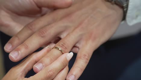 Woman-engaging-man-couple-goals-detail-shot-of-hands-and-rings-wedding