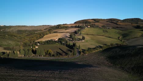 Long-shadows-cast-on-rolling-hills-dot-Tuscan-landscape-with-picturesque-fields