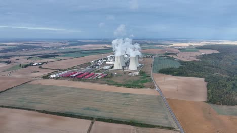 Far-aerial-view-of-nuclear-power-plant-Dukovany-cooling-towers-emit-steam