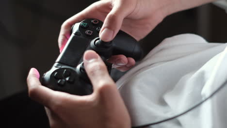 Close-up-Gamer's-hands-gaming-with-a-black-controller