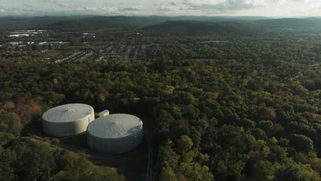 Aerial-View-Of-Water-Storage-Tanks-In-The-Woods-Near-Fayetteville,-Mount-Sequoyah,-Arkansas,-USA