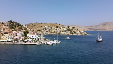 Drone-shot-of-docked-ships-in-the-port-of-Symi,-Greece