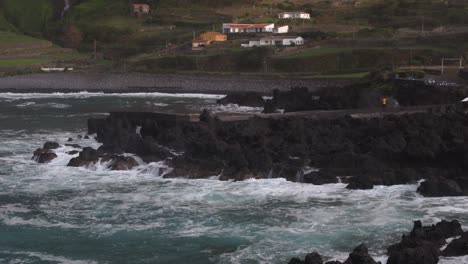 Aerial-tilt-up-shot-of-rough-sea-at-Flores-island-Azores,-Portugal