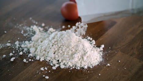 Pouring-flour-on-table-for-baking-with-eggs-aside-ready-to-mix