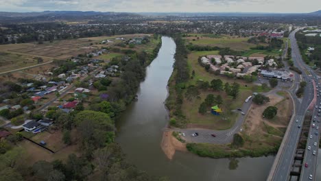 Aerial-Pullback-Above-Logan-River-In-The-Town-Of-Waterford-In-Logan-City,-Queensland,-Australia