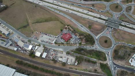 View-from-Above-Of-Transports-Navigating-On-Pacific-Motorway-In-Yatala-Suburb,-Gold-Coast,-Queensland