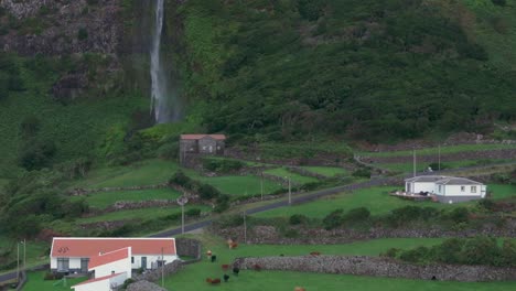 Traditional-house-at-tall-waterfall-at-Flores-island-Azores