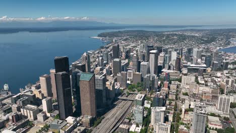 Große-Luftaufnahme-Der-Wolkenkratzer-In-Der-Innenstadt-Von-Seattle,-Die-über-Dem-Puget-Sound-Stehen