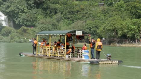Tourists-in-boat-navigate-waters-beneath-cascading-Ban-Gioc–Detian-Falls