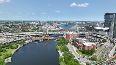 Drone-shot-of-the-Charles-River-passing-under-The-Zakim-bridge-in-Boston,-MA