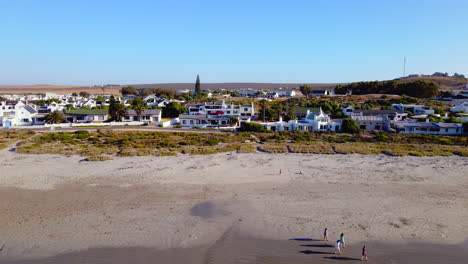 White-washed-fishermen's-cottages-along-beach-of-Paternoster,-West-Coast