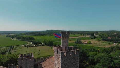 Flag-Over-Château-de-Pouzilhac-Ramparts---Aerial-wide-view