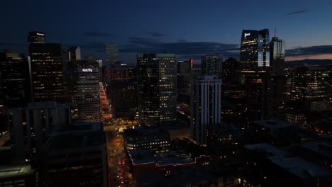 Drone-Aerial-Flyover-of-Downtown-Denver-Colorado-Cityscape-at-night-time