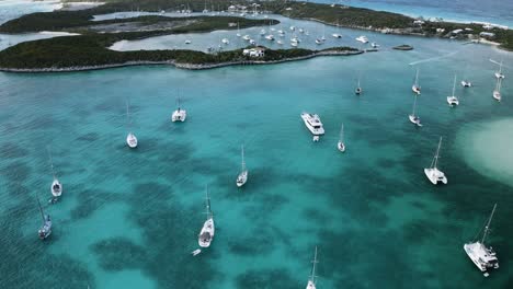 Catamaran-Sail-Boats-for-Tourism-in-Marina-Port-Bay-in-the-Bahamas,-Aerial-Drone