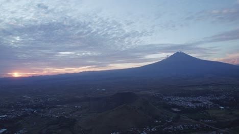 Aerial-shot-of-the-Popocatepetl-volcano-rotating-towards-the-sunset