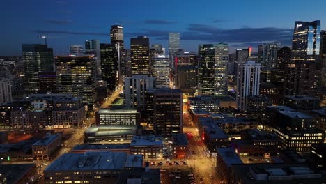 Aerial-Drone-Video-of-Downtown-Denver-Cityscape-at-night-time-with-lights-and-cars-driving
