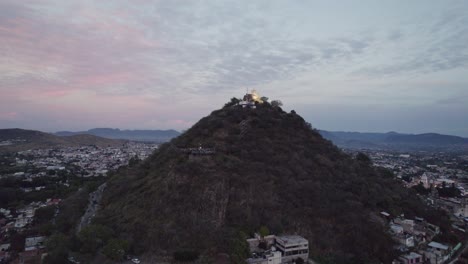 Aerial-shot-in-ascending-orbit-of-the-San-Miguel-hill-in-Atlixco-Puebla
