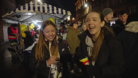 Teenage-girls-revel-in-the-lively-atmosphere-of-Christmas-lights-event
