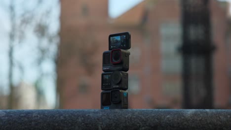 Four-creative-action-cameras-with-blurred-background,-low-angle-view-and-close-up