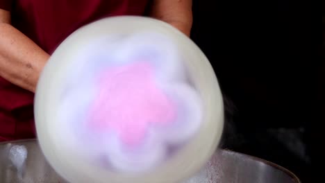 A-super-fluffy-cotton-candy-is-created-with-a-flower-shape-in-the-center