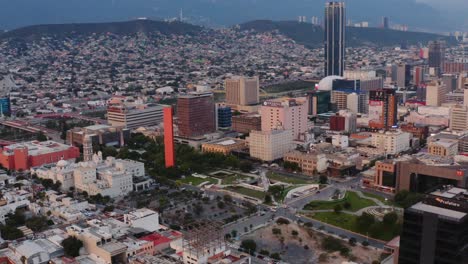 Aerial-view-of-park-in-center-of-Monterrey-business-district-surrounded-by-tall-buildings