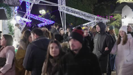 People-Strolling-During-Holiday-Season-In-City-Park-With-Colorful-Display-Lights-In-Galati,-Romania