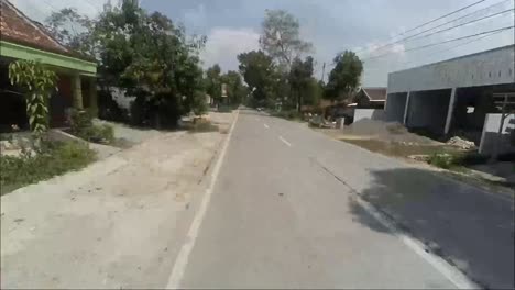 Pov-timelapse-of-a-motorbike-rider-passing-by-in-the-morning-in-the-remote-area-of-Blora,-Central-Java,-Indonesia