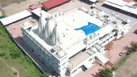 aerial-drone-shot-The-drone-camera-is-going-over-the-temple-where-the-construction-work-of-the-temple-is-going-on