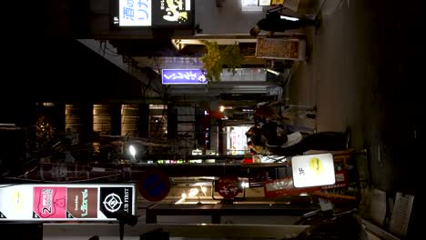 Local-Japanese-Waiting-Outside-Restaurant-In-Gion-At-Night-In-Kyoto