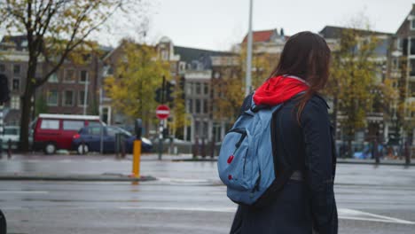 Handheld-shot-of-female-student-walking-through-a-street-in-Amsterdam