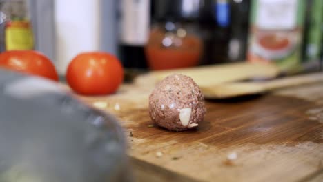 Rolling-meatballs-from-scratch-and-putting-them-on-cutting-board-Preparing-ingredients-to-make-vegan-beyond-meatballs-with-spaghetti-and-meat-sauce