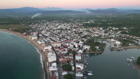 Aerial-Drone-Cityscape-of-Barra-de-Navidad-Mexican-Beach-Summer-Town-Blue-Sea-Resort-Town