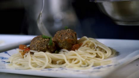 adding-meatballs-to-plate-of-spaghetti-Preparing-ingredients-to-make-vegan-beyond-meatballs-with-spaghetti-and-meat-sauce