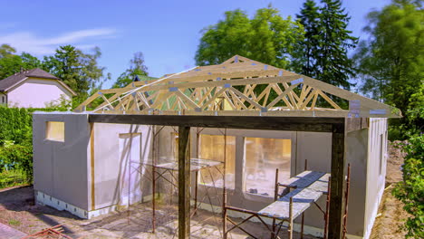 Timelapse-of-workers-building-a-wooden-roof-structure-on-a-private-home,-summer-day