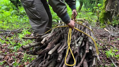 tie-a-rope-knot-in-forest-wilderness-survival-in-Iran-Hyrcanian-jungle-Azerbaijan-UNESCO-site-ecotourism-hiking-activity-lodge-resort-burn-wood-fire-campfire-dry-wooden-stick-tree-branch-bread-bake