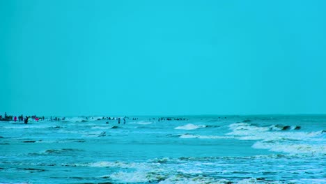 People-enjoying-the-cool-blue-water-of-the-Bay-of-Bengal,-Indian-Ocean