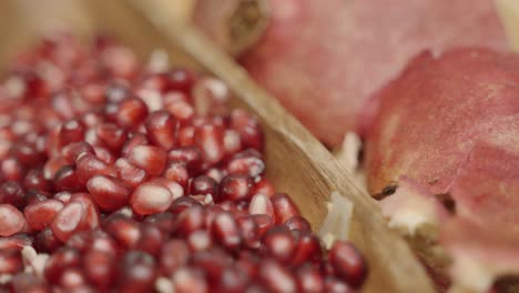 Close-up-Panning-of-Pomegranate-seeds-inside-of-a-plate-juicing-and-using-fresh-ingredients-and-fresh-whole-pomegranates