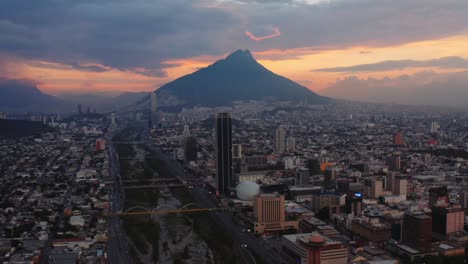 Beautiful-sunset-sky-background-with-tall-mountain-and-the-city-of-Monterrey,-Mexico-in-foreground