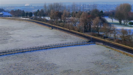 Establishing-Drone-Shot-of-Fields-in-Suburbs-with-Road-on-Frosty-Morning-Woodhall-Yorkshire