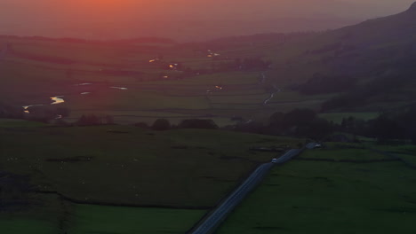 Establishing-Drone-Shot-of-White-Van-on-B6255-at-Sunset-in-Yorkshire-Dales