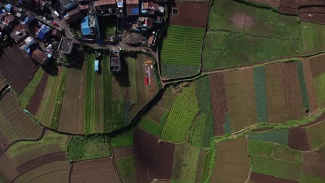 Overhead-drone-shot-of-Poombarai-village-on-Palani-hills-among-terrace-farming-fields,-Scenic-farmland,-Tamil-Nadu,-India