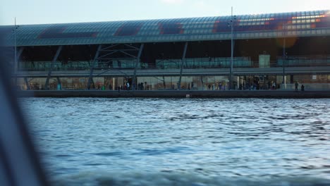 Amsterdam-Central-Station-as-seen-from-the-water,-public-transportation-hub