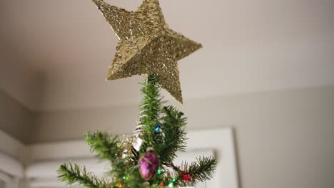 Tilt-down-from-Gold-Christmas-Tree-Star-to-ornaments-and-stockings