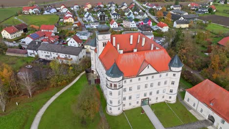 Schloss-Hartheim-Castle-And-Surrounding-Town-In-Alkoven,-Upper-Austria---Aerial-Shot