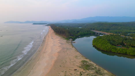 Drone-shot-aerial-view-top-angle-seascape-waves-Galgibaga-beach-turquoise-blue-water-ocean-Goa-India