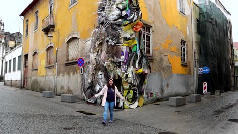 Happy-woman-visiting-Half-Rabbit-street-art-by-Bordalo-ll